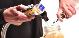 A close up of a pepsi pump and a jug